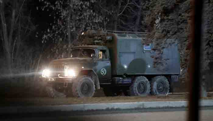 A military vehicle is seen on a street on the outskirts of the separatist-controlled city of Donetsk, Ukraine February 23, 2022. -REUTERS