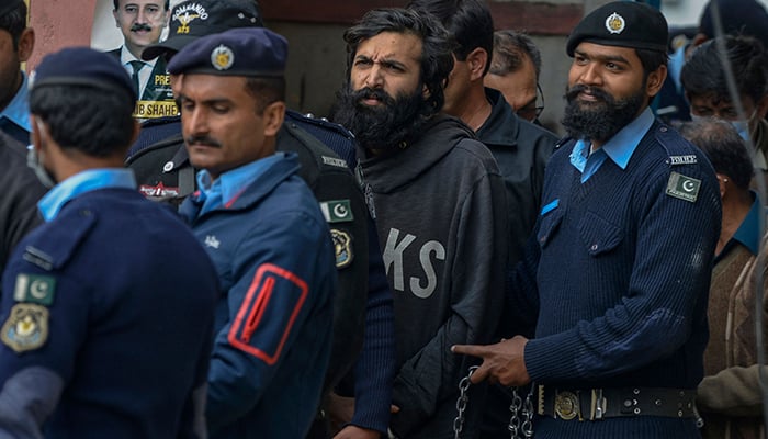 Pakistani-American Zahir Jaffer (C), convicted to murder Noor Mukadam, arrives in a court before case verdict in Islamabad on February 24, 2022. — AFP