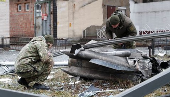 Police officers inspect the remains of a missile that fell in the street, after Russian President Vladimir Putin authorized a military operation in eastern Ukraine, in Kyiv, Ukraine February 24, 2022. — Reuters