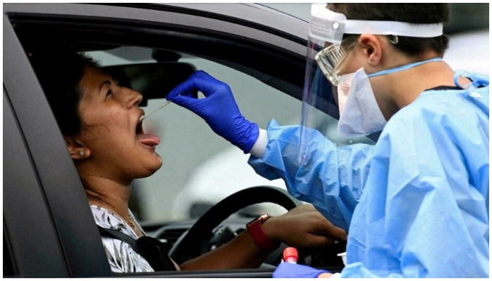A woman takes a test for Covid-19 at a testing centre in Sydney, Australia, on January 5, 2022. — Jaimi Joy/ Reuters