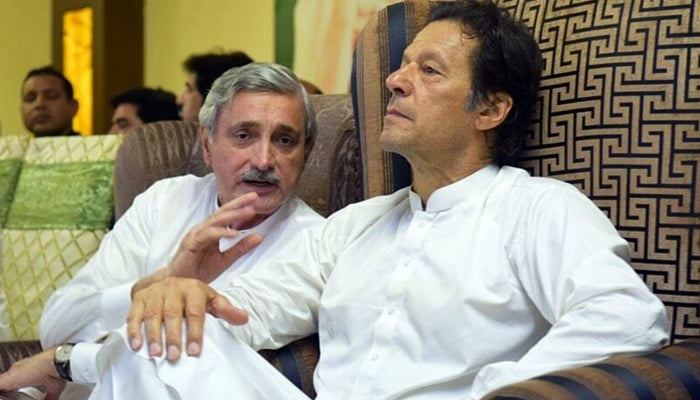 Disgruntled PTI leader Jahangir Tareen (left) speaks to Prime Minister Imran Khan in this undated photo. — PTI/File