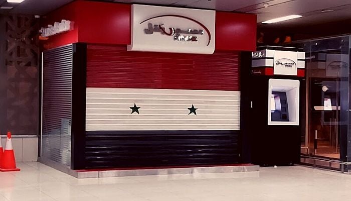 A Syrian flag painted on one of the shops at the Damascus Airport.