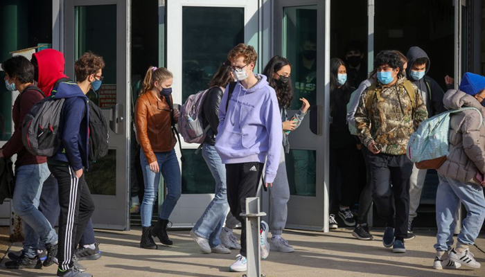 Students leave Washington-Liberty High School in Arlington County which is one of several school districts which sued to stop the mask-optional order by Governor Glenn Youngkin (R), in Arlington, Virginia, US, January 25, 2022. — Reuters