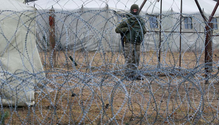 A member of the Ukrainian State Border Guard Service stands near the border with Belarus and Poland, in Volyn region, Ukraine November 16, 2021. — Reuters/File