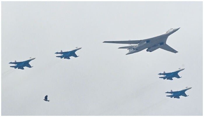 A Russian Tupolev Tu-160 strategic bomber and Su-35S jet fighters fly in formation over central Moscow during the Victory Day military parade on May 9, 2021. — KIRILL KUDRYAVTSEV/AFP via Getty Images