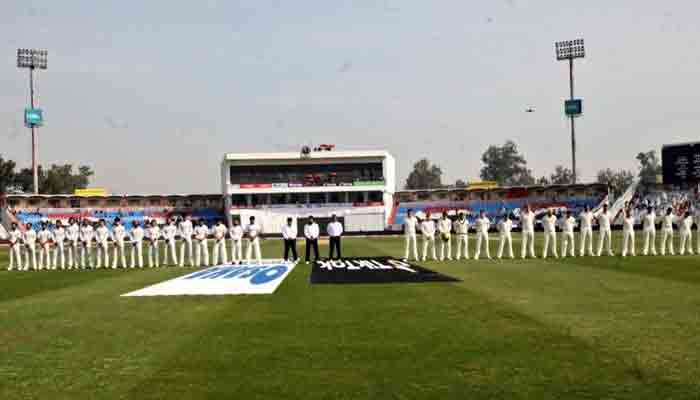 Players observe a minutes silence at the Pindi Cricket Stadium.