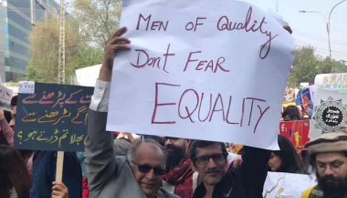 Men raise placard with the slogan Men of quality dont fear equality. — Sapan