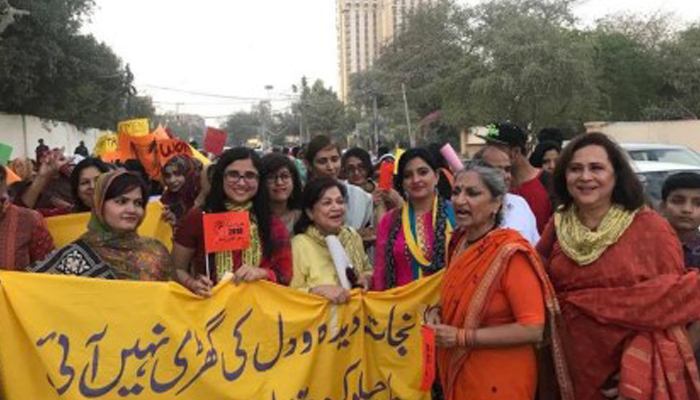 Women participate in the Aurat March. — Sapan