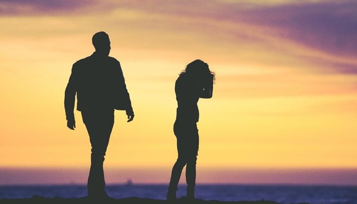 Representational image showing a couples silhouette, parting ways. — @ericjamesward/Unsplash