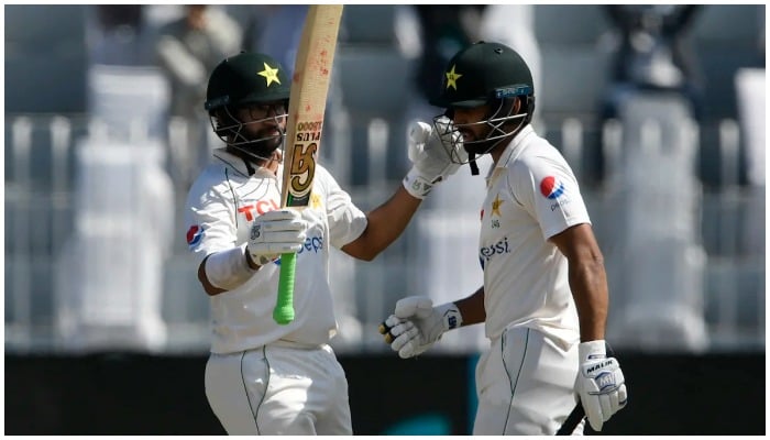 Abdullah Shafique walks up to congratulate Imam-ul-Haq after the latters half-century, Pakistan vs Australia, 1st Test, Rawalpindi, 1st day, March 4, 2022. Photo: AFP