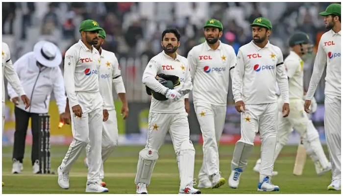 Pakistan players walk back to the dressing room at the end of play. — AFP/File