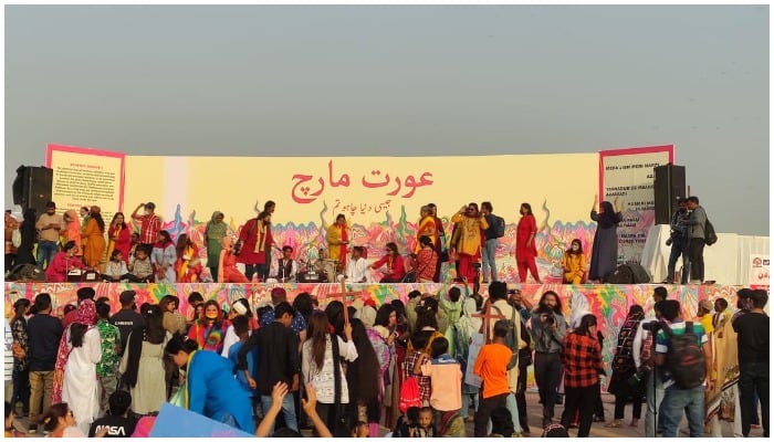 Photo showing women gathering on a stage during Aurat March 2022— Twitter/Khawajaburhan6