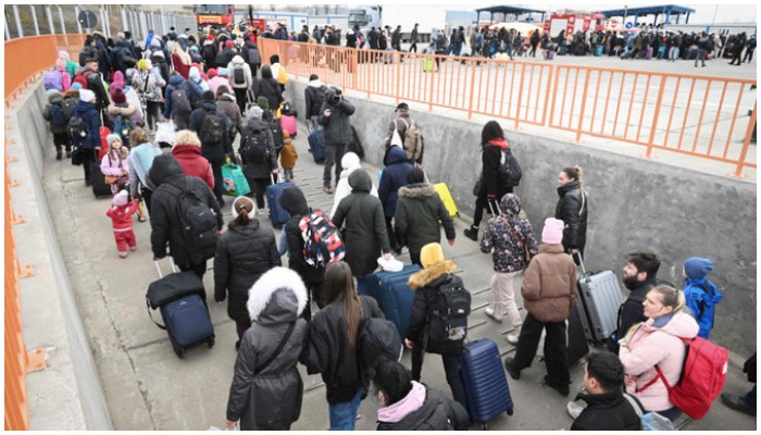 People coming from Ukraine descend from a ferry boat to enter Romania after crossing the Danube river at the Isaccea-Orlivka border crossing between Romania and Ukraine on February 26, 2022. — AFP/File