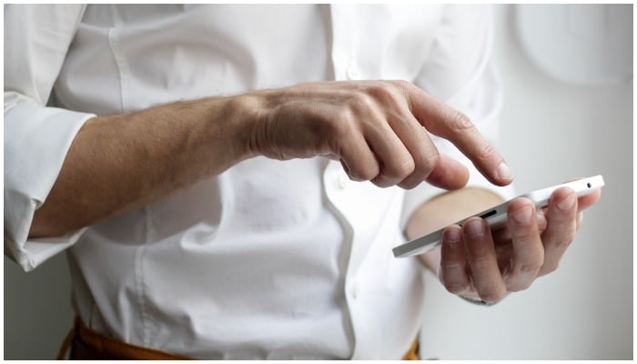 Representational image of a man using a mobile phone. — NordWood Themes/Unsplash
