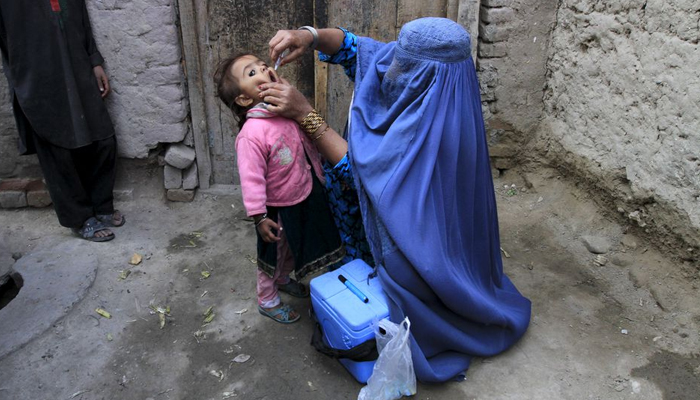 A child receives a polio vaccination during an anti-polio campaign on the outskirts of Jalalabad, Afghanistan, December 1, 2015. — Reuters