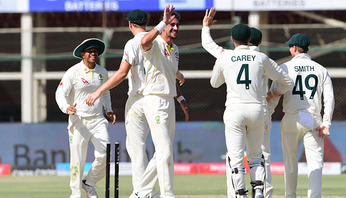 Australia´s Mitchell Starc (C) celebrates with teammates after the dismissal of Pakistans Hasan Ali during the third day of the second Test cricket match between Pakistan and Australia at the National Cricket Stadium in Karachi on March 14, 2022. — AFP