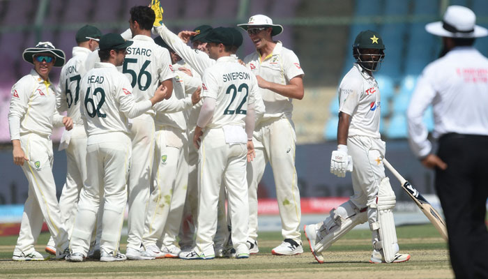 Australia´s players celebrate after the dismissal of Pakistans Sajid Khan during the third day of the second Test cricket match between Pakistan and Australia at the National Cricket Stadium in Karachi on March 14, 2022. — AFP