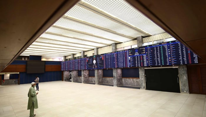 Pakistani stockbrokers monitor the latest share prices during a trading session at the PSX in Karachi, Pakistan, on February  24, 2022. — INP/File