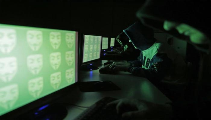 People pose in front of a display showing the word cyber in binary code, in this picture illustration taken in Zenica December 27, 2014. — Reuters/Dado Ruvic