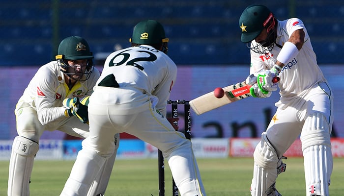 Pakistans Mohammad Rizwan (R) plays a shot during the fifth and final day of the second Test cricket match between Pakistan and Australia at the National Cricket Stadium in Karachi on March 16, 2022. — AFP