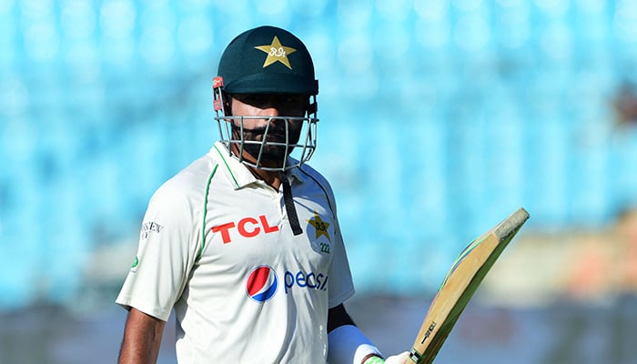 Pakistan´s captain Babar Azam walks back to the pavillon after his dismissal during the fifth and final day of the second Test cricket match between Pakistan and Australia at the National Cricket Stadium in Karachi on March 16, 2022. — AFP