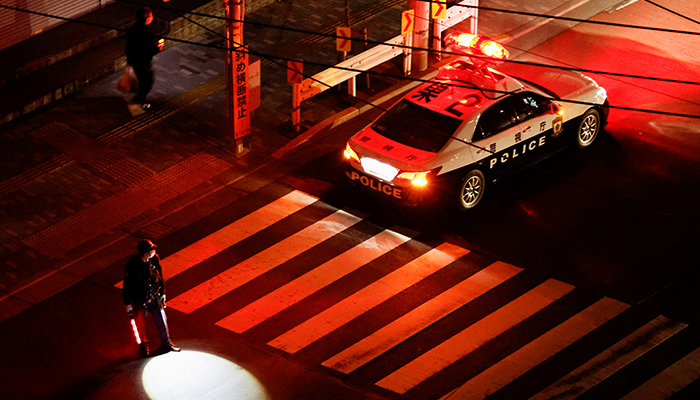 A police officer tries to control traffic on the street during an electric stoppage after an earthquake in Tokyo, Japan March 17, 2022. — Reuters
