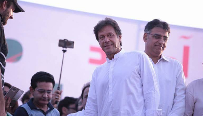 Prime Minister Imran Khan (left) and Minister for Planning, Development, and Special Initiatives Asad Umar can be seen attending a PTI rally. National news