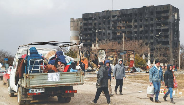 Residents fleeing Mariupol sit in a cargo vehicle while waiting to leave the besieged southern port city. —Reuters/File