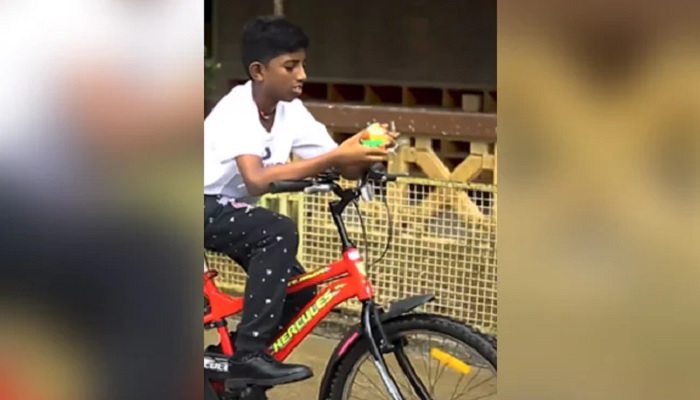 Jayadharshan Venkatesan solves the Rubiks Cube while he rides a bicycle. — Screengrab from Instagram video/guinnessworldrecords