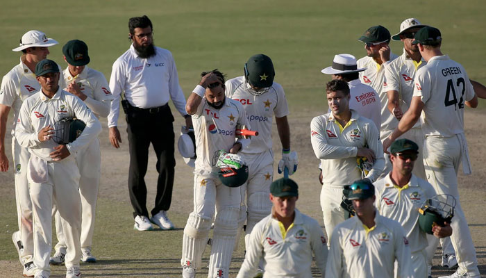 Pakistan and Australia players going back to the pavilion. — Reuters/File