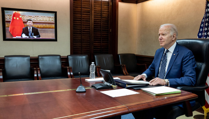 In this image released by the White House, US President Joe Biden (L) speaks with Chinese President Xi Jinping (on screen) from the White House in Washington, DC, on March 18, 2022.-AFP