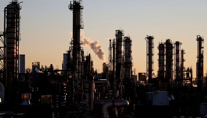 Smoke rises from a factory during the sunset. — Reuters/File