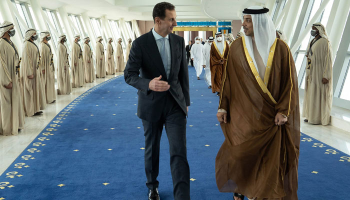 A handout picture released by the Syrian Presidency Facebook page on March 18, 2022, shows Syrias President Bashar al-Assad (L) is welcomed by the UAEs Deputy Prime Minister Sheikh Mansour bin Zayed Al-Nahyan, in the capital Abu Dhabi. — AFP/File