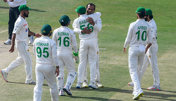 Pakistans Nauman Ali (C back) celebrates with teammates after dismissing Australias captain Pat Cummins (not pictured) during the fifth day of the first Test cricket match between Pakistan and Australia at the Rawalpindi Cricket Stadium in Rawalpindi on March 8, 2022. — AFP