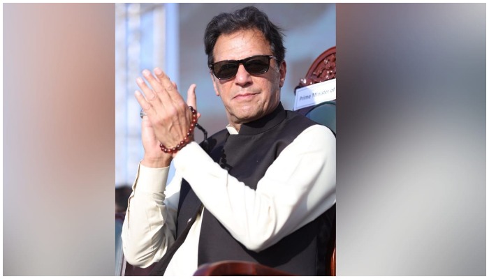 Prime Minister Imran Khan claps during a jalsa in Hafizabad on March 13, 2022. — Instagram/imrankhan.pti