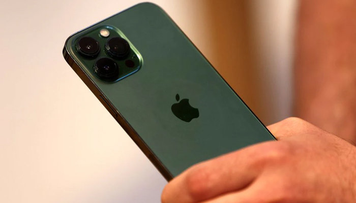A customer holds the new green colour Apple iPhone 13 pro shortly after it went on sale inside the Apple Store on 5th Avenue in Manhattan in New York City, New York, US, March 18, 2022. — Reuters