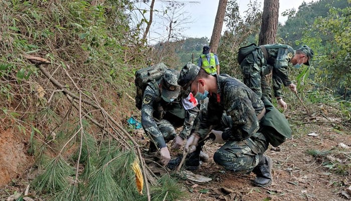 Paramilitary police officers work at the site where a China Eastern Airlines Boeing 737-800 plane flying from Kunming to Guangzhou crashed, in Wuzhou, Guangxi Zhuang Autonomous Region, China March 21, 2022. — Reuters/File