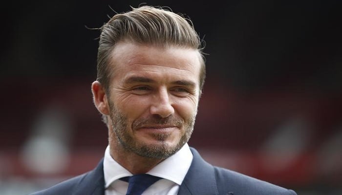 David Beckham poses for photographers at Old Trafford, ahead of his upcoming charity soccer match against a Rest of the World team led by Zinedine Zidane at Old Trafford to raise awareness and funds for UNICEF, in Manchester, Britain, October 6, 2015. Reuters