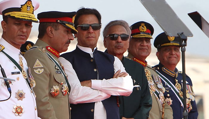 Prime Minister Imran Khan (3L) and President Arif Alvi (3R) watch Pakistan´s Air Force fighter jets perform during the Pakistan Day parade in Islamabad on March 23, 2022. — AFP