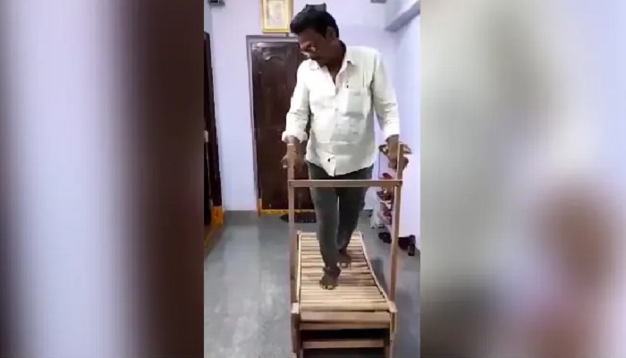 Man in Telangana walks on his self-made wooden treadmill. —Photo: Screengrab from Twitter video/@ArunBee