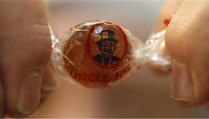 Managing Director John Winnard holds the 2 billionth Uncle Joes Mintball to come off the production line at the Santus Toffee factory in Wigan, northern England, February 16, 2011. The sweets, originally made to help coal miners clear their chests after working down the pit, have been produced since 1898.—Reuters
