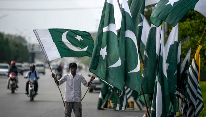 A vendor holds a Pakistani flag as he waits for customers beside his stall alongside a street in Islamabad on August 13, 2020, ahead of the countrys 74th Independence Day. — Photo: AFP