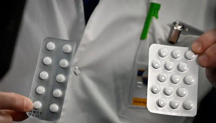 Medical staff at the IHU Mediterranee Infection Institute in Marseille show tablets containing chloroquine and tablets containing hydroxychloroquine on February 26, 2020. — AFP/File
