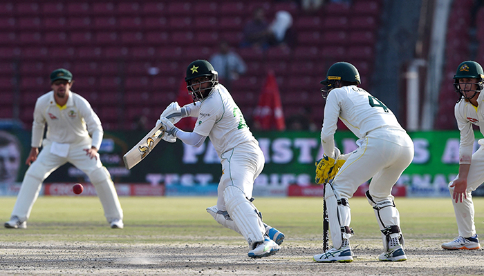 Pakistans Imam-ul-Haq (C) watches the ball after playing a shot during the fourth day of the third and final Test cricket match between Pakistan and Australia at the Gaddafi Cricket Stadium in Lahore on March 24, 2022. — AFP