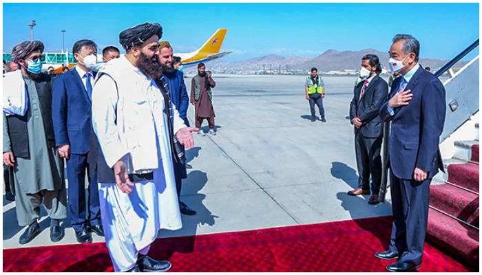 This handout photo released by the Taliban Foreign Ministry shows Taliban Foreign Minister Amir Khan Muttaqi (L) greeting China’s Foreign Minister Wang Yi (R) upon his arrival at the Kabul airport in Kabul on March 24, 2022. Taliban Foreign Ministry, International news