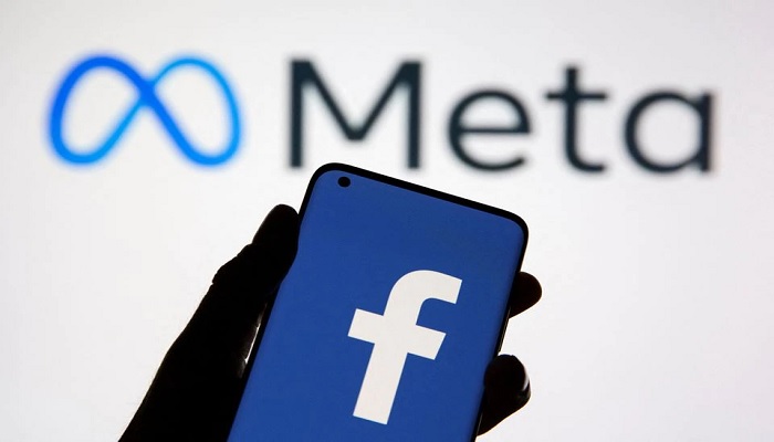 A smartphone with Facebooks logo is seen in front of displayed Facebooks new rebrand logo Meta in this illustration taken October 28, 2021. —Reuters