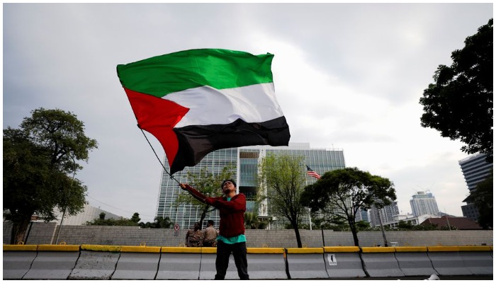 Representational image of an activist waving a Palestinian flag during a protest against Israel outside the US embassy in Jakarta, Indonesia, on May 12, 2021. — Reuters/Willy Kurniawan