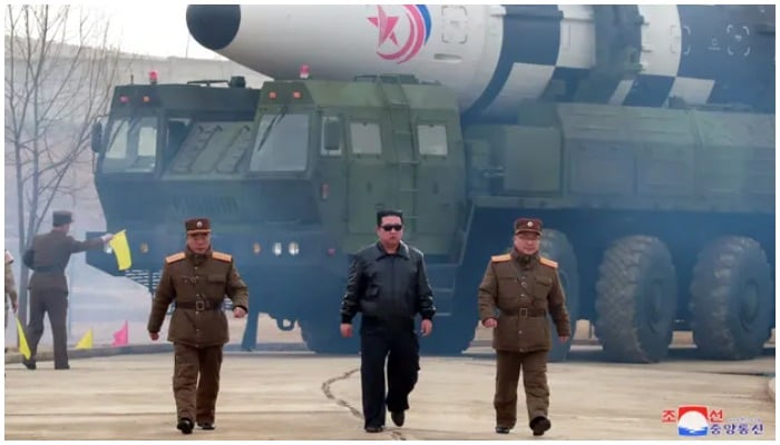 North Korean leader Kim Jong-un walks away from a missile in a photo released on 24 March 2022 by the Korean Central News Agency. — KCNA/Reuters