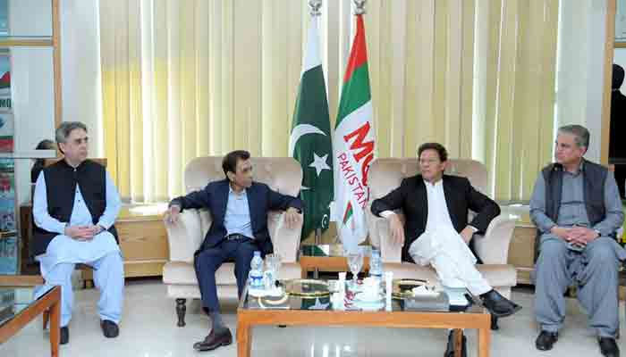 Prime Minister Imran Khan with the MQM-P leadership at the partys headquarters in Karachi. —Radio Pakistan/File