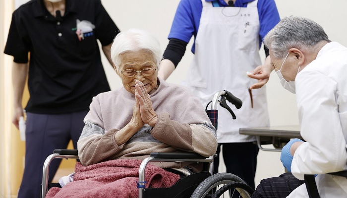 An elderly woman gestures to express gratitude after receiving a coronavirus disease (COVID-19) vaccination in Itami, western Japan April 12, 2021, in this photo released by Kyodo.—Reuters